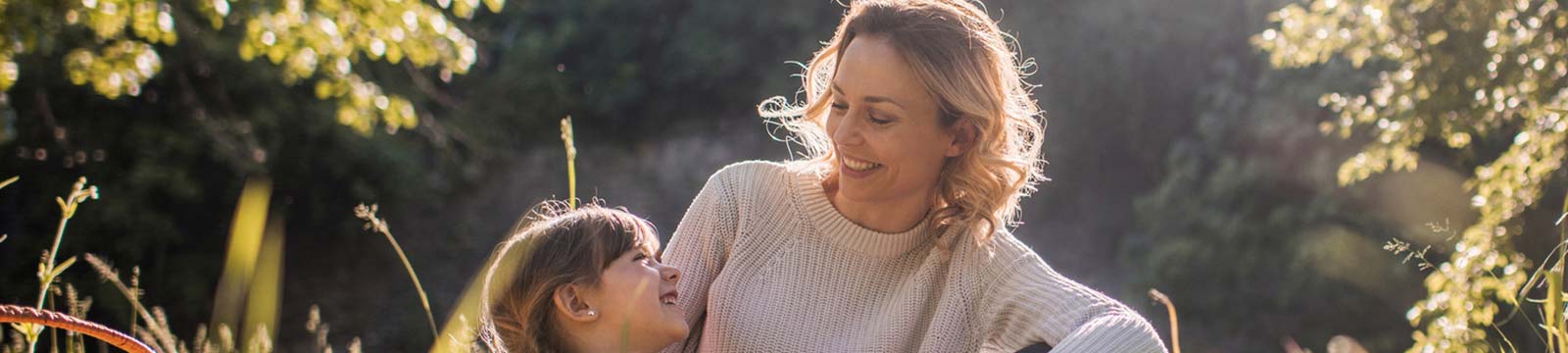 Mother and daughter talking outside on a sunny day