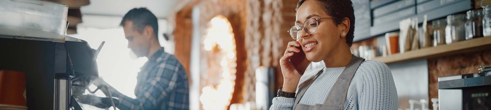 Restaurant employee using a phone while working