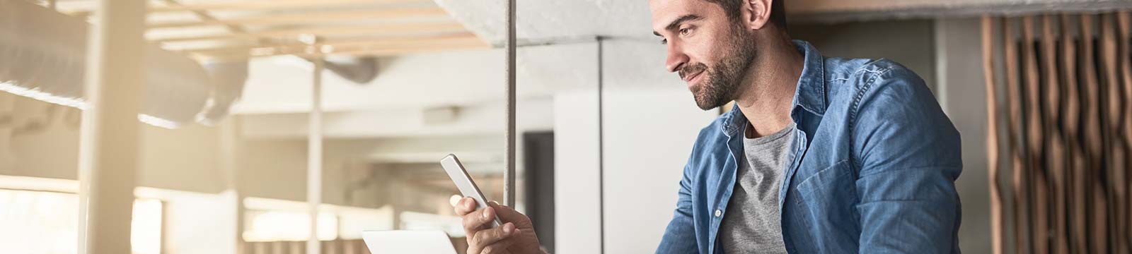 Man using a smartphone in his office