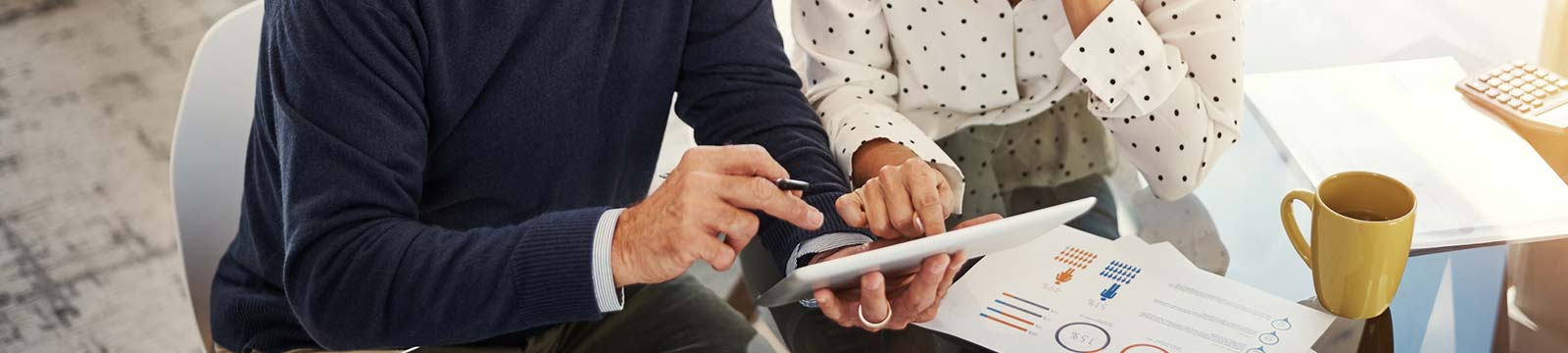 Man and woman using a smart tablet at home.